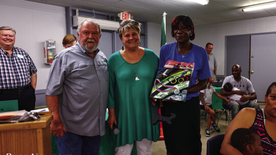 Fred Kerley’s Aunt Virginia “MeMe” accepts a painted tile in honor of the global track star’s induction into the Taylor High School Duck Hall of Fame.