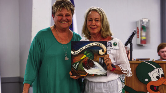 Pat Helbert (left) welcomes Peggy Leshikar Denton to the Duck Hall of Fame.