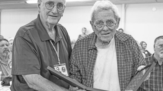 ABOVE: Members of the 1969-1970 choir assemble for a performance of one of their favorite songs from high school. RIGHT: On behalf of the 1969-70 choir, Herbert Brinkmeyer presents a framed copy of The Lord Bless You and Keep You by Peter C. Lutkin to their director, William Kretzmeier.