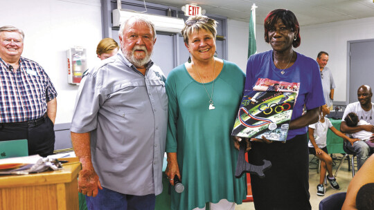 Fred Kerley’s Aunt Virginia “MeMe” accepts a painted tile in honor of the global track star’s induction into the Taylor High School Duck Hall of Fame. Photo by Ryan Newsome