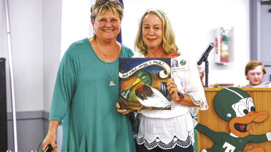 Pat Helbert (left) welcomes Peggy Leshikar Denton to the Duck Hall of Fame. Photo by Ryan Newsome