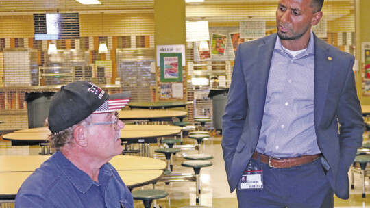 Business owner Albert Janecka (left) discusses his concerns one-on-one with Taylor ISD Superintendent Devin Padavil after the community meeting.