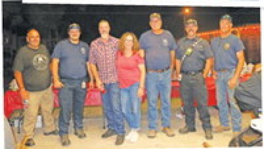 TOP: Taylor resident Zoe gives Officer McGruff some love Oct. 4 during National Night Out festivites. MIDDLE: Members of Williamson County ESD #10 engaged the community Oct. 4 at Thrall City Park. From left, police chief Whitney Whitworth, firefighter Dylan Konarsky, city commissioner Clay...