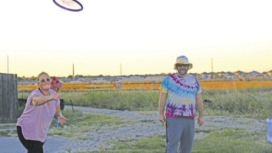 LEFT: Jenny and Brandon Niemczyk try their hands at disc golf Oct. 4. Jenny is a board member of the HuttoParke HOA.