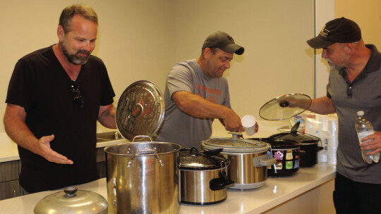 HuttoParke community members Mike Juneau, Thomas Raines and Rich Matteson check out the competitors in the HuttoParke HOA chili cookoff Oct. 4 during the National Night Out block party. Raines and Matteson are HOA board members.