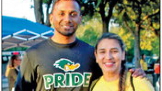 Taylor Independent School District Superintendent Devin Padavil poses with race volunteer Audrey Solis.