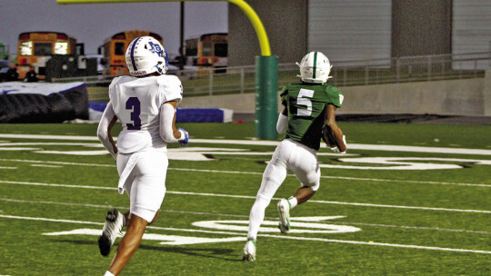 Ducks senior Jarvis Anderson running towards the endzone after intercepting the ball during game against Jarrell. Photo by Evan Hale