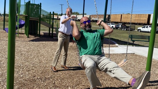 Mayor Brandt Rydell pushes District 4 Councilman Robert Garcia on the swings before a ribbon cutting ceremony at Doak Park Wednesday. Photos by Catherine McGary