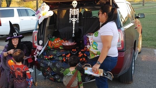 At a previous Trunk or Treat, Loretta Patschke (left) hands out candy at her decorated SUV. Photo by Jack Piper