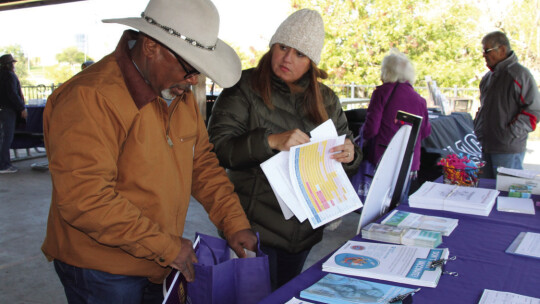 (From left) F.L. Harris receives information on immunizations from Emperatriz Kennedy, from the Williamson County &amp; Cities Health District, Nov. 12 at the Dickey Day health fair.