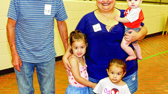 Izabella Jensen and Stefan De Hoyos enjoy hosting their grandmother, Donna Flores, and great grandfather, Alfred Flores, at T.H. Johnson Elementary. Photos by Tim Crow