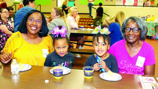 Ziel (center, right) and Bayley (center, left) Gadison enjoy time with their grandmothers at TH Johnson Elementary.