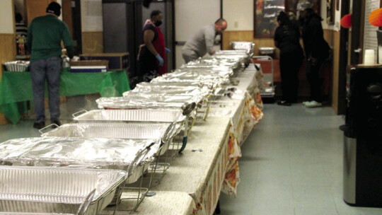 Volunteers prepare to put all the Thanksgiving meal components catering trays.