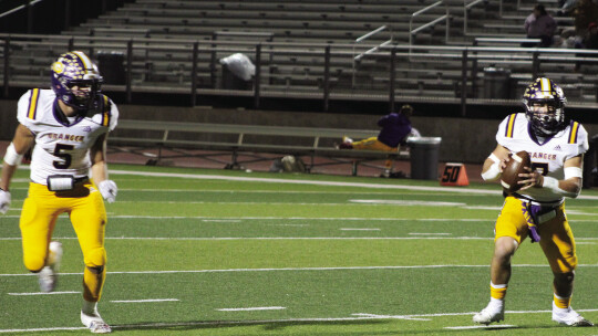 Lions’ senior Nate Tucker escaping the pocket with junior Chase Edwards running by his side.