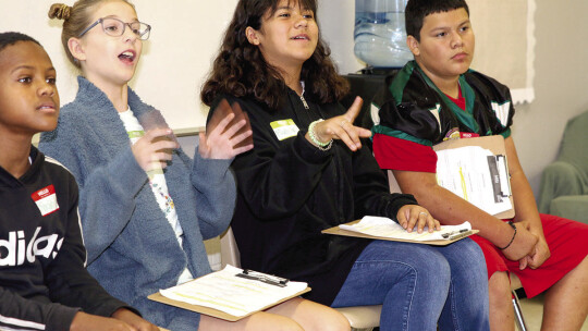 MSI students Alice Killian and Madison Martinez (center) answer questions from Taylor ISD Ambassadors about their school. Also shown on the panel are Khalib Lewis and Zeke Garcia.