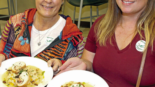 Taylor ISD Ambassadors Billie Logiudice (left) and Misty Murtha admire the presentation of the lunch they are about to enjoy at Top Flight Duck Room restaurant at Taylor High School.