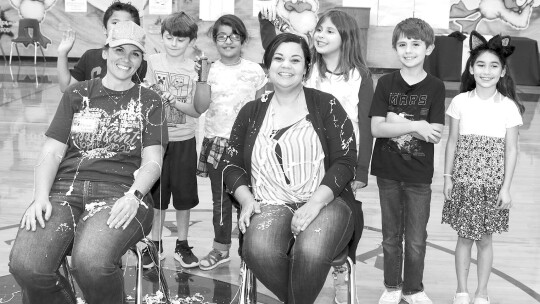 Top readers and top fundraisers in Pasemann Elementary’s Read-A-Thon enjoy the reward of getting to Silly String Principal Felicia Gibson (front, right) and Assistant Principal Amie Von Stosch (front, left). Students from left are Adam Newman, Isra Fazly, Grayson Simbolon, Livia Maldonado,...