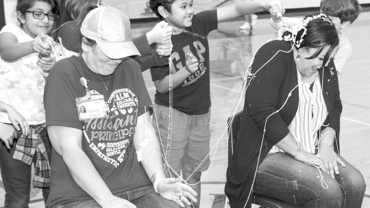 Pasemann’s top readers and top fundraisers in the school’s Read-A-Thon cover Principal Felicia Gibson and Assistant Principal Ami Von Stosch with Silly String.