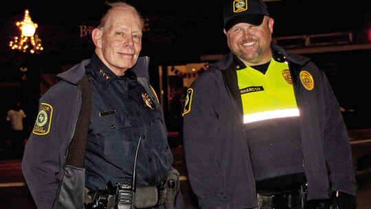 Police Chief Henry Fluck takes a break with police Commander Joseph Branson Saturday night during the downtown parades. Photos by Nicole Lessin