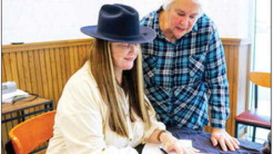 Children’s author Iris Shay Reese inscribes a copy of Hippos Are My Heroes for Ida Weaver during the event at Rio Grande Tex-Mex Restaurant. Photo by Edie Zuvanich