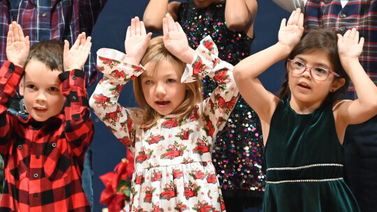 Knox Shyrack, Kenna Martinka and Amelia Martinez join the St. Mary’s first graders in singing Little Drummer Boy during their Christmas Concert.