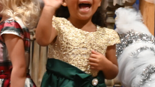 PK4 student Jayla Ortiz waves to her parents during the St. Mary’s Elementary Christmas Concert.