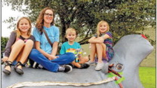 (From left) Juliette, mom Amy, TJ and Clara Harrison find the best seat at the fair.