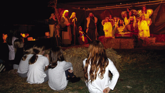 Children watch the live nativity scene.