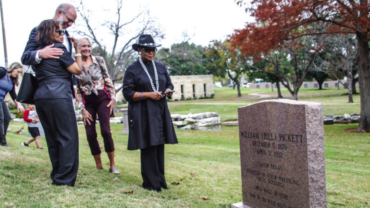 Michelle Anderson hugs Mayor Brant Rydell, alongside Nancy Hill and Dannie B. Royal Dec. 10.