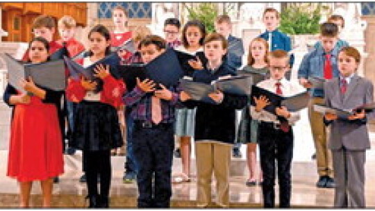 St. Mary’s fifth graders sing “O Come, Diving Messiah” at the Christmas concert.