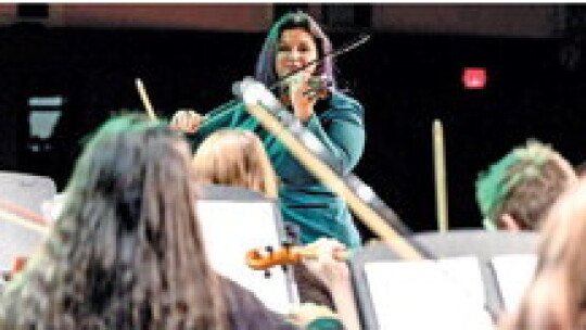 Franchesca Mejia assisted students by playing along on the violin.