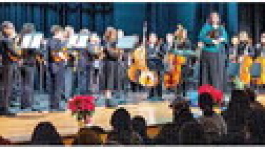 The Farley Middle School concert orchestra takes a bow after playing for the audience.