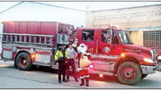 Santa arrives on a Coupland Volunteer Fire Department truck.