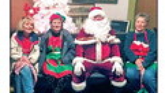 (Right) Coupland Civic Organization (CCO) board members visit with Santa (Jonathan Jones). Left to right, Barbara Piper, Coupland Mayor pro tem; Susan Schmidt, CCO President; and Becky Sutton, CCO Assistant Treasurer.