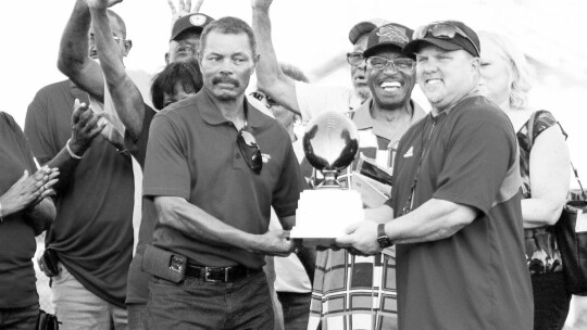 “State championships are hard to come by,” said Brandon Houston (right), Taylor Duck head football coach. Houston and Edward Elder hold the O.L. Price state championship trophy before the homecoming game. Photo by Catherine McGary