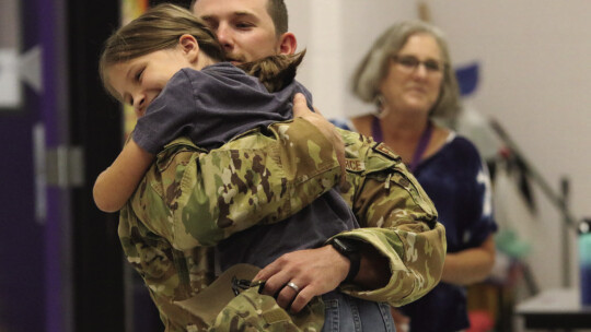 Adilene Saunders, a fourth grader at Thrall Elementary, gets a surprise visit during lunch from her father, Air Force Technical Sergeant Caleb Saunders, who returned home for a weekend visit during his year-long deployment. Courtesy photo by Rochelle Malish