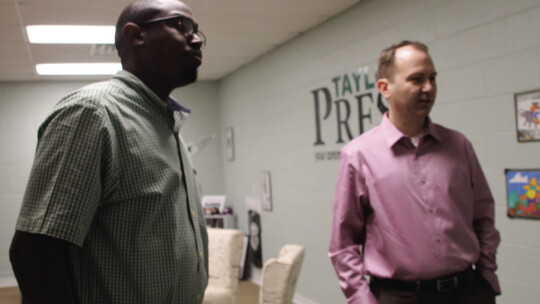 Area Editor Jason Hennington (left) shows Deputy City Manager Jeff Jenkins around the Taylor Press studio Jan. 9 Photo by Nicole Lessin