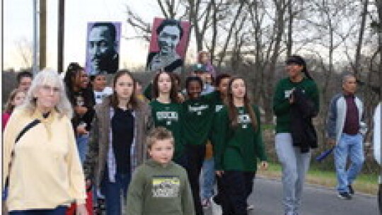 Member of the Lady Duck basketball team participated in the Martin Luther King Jr. Day march holding photos of Dr. King and Rosa Parks. Photos by Jason Hennington