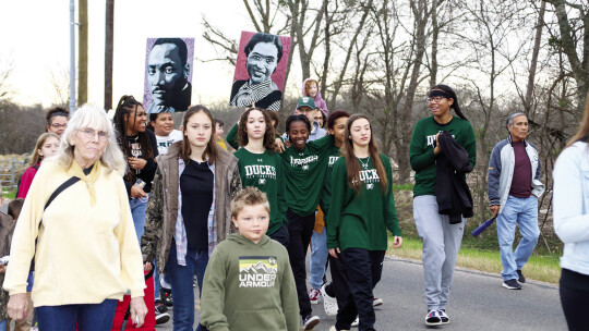 Members of the Lady Duck basketball team participated in the Martin Luther King Jr. Day march holding photos of Dr. King and Rosa Parks.