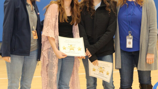 At the Fall Semester Awards Program, Coupland School Superintendent Tammy Brinkman, left, and Assistant Principal Kate Knapek, right, present awards to Avery Ward and Kalli Coffey. Photo by Crystal Ward