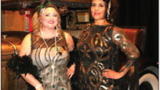 Danielle Markum and Trish Rios with Hutto Flower Market model roaring 20s costumes in front of an antique Model A Ford.