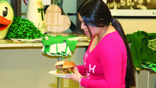 Victoria Araujo describes her jalapeno double bacon cheeseburger for the judges in the Duck Brigade’s Burger Challenge competition. Photos by Tim Crow