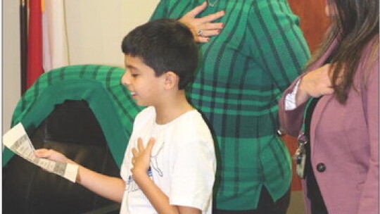 Jhair Martinez Diaz opened the January Taylor school board meeting by leading the pledges to the US and Texas flags. He is joined by Jennifer Patschke, Assistant Superintendent, and Jina Self, Chief Financial Officer.