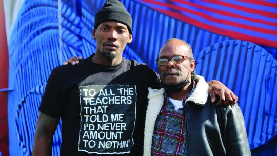 Fred and Rickey Kerley pose for a photo in front of the mural of the Olympic silver medalist. Photos by Jason Hennington