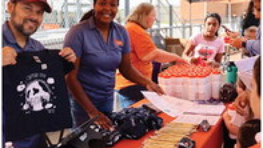 Ray Elementary principal Alexis Campbell (right) and assistant principal Victor Juarez help handout schools supplies before the start of the 2022-23 school year. Photo by Edie Zuvanich