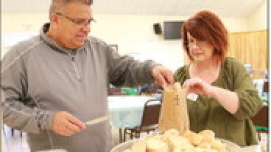 HRC board vice-president Felix Chavez and executive director Donna Jones prepare a to-go order.