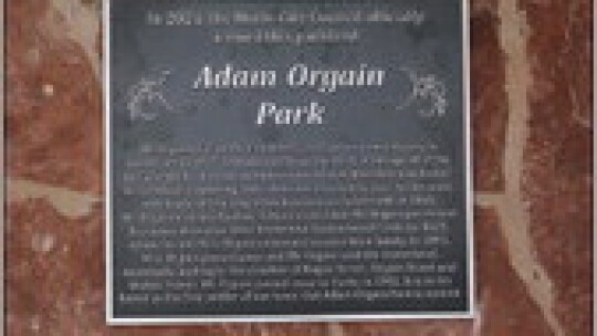 Close-up of the dedication plaque, which is installed at the pavilion.