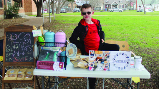 Olin Petke Jr. sells his home-made peanut butter treats, pig ears and pet accessories Feb. 25 at the pop-up event at Old Taylor High.