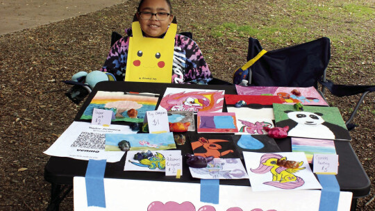 Teagan Blackman, 9, displays her artwork at the fair.