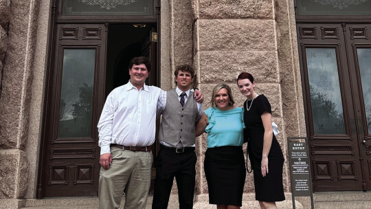 (From left) Cody Klaus, Nate Tucker, Superintendent Jeni Neatherlin and Alex Harwell pose in front of the Capitol building March 9.